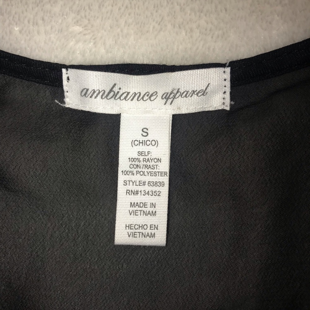 Ambiance Apparel black sleeveless top with bow on front. Size S